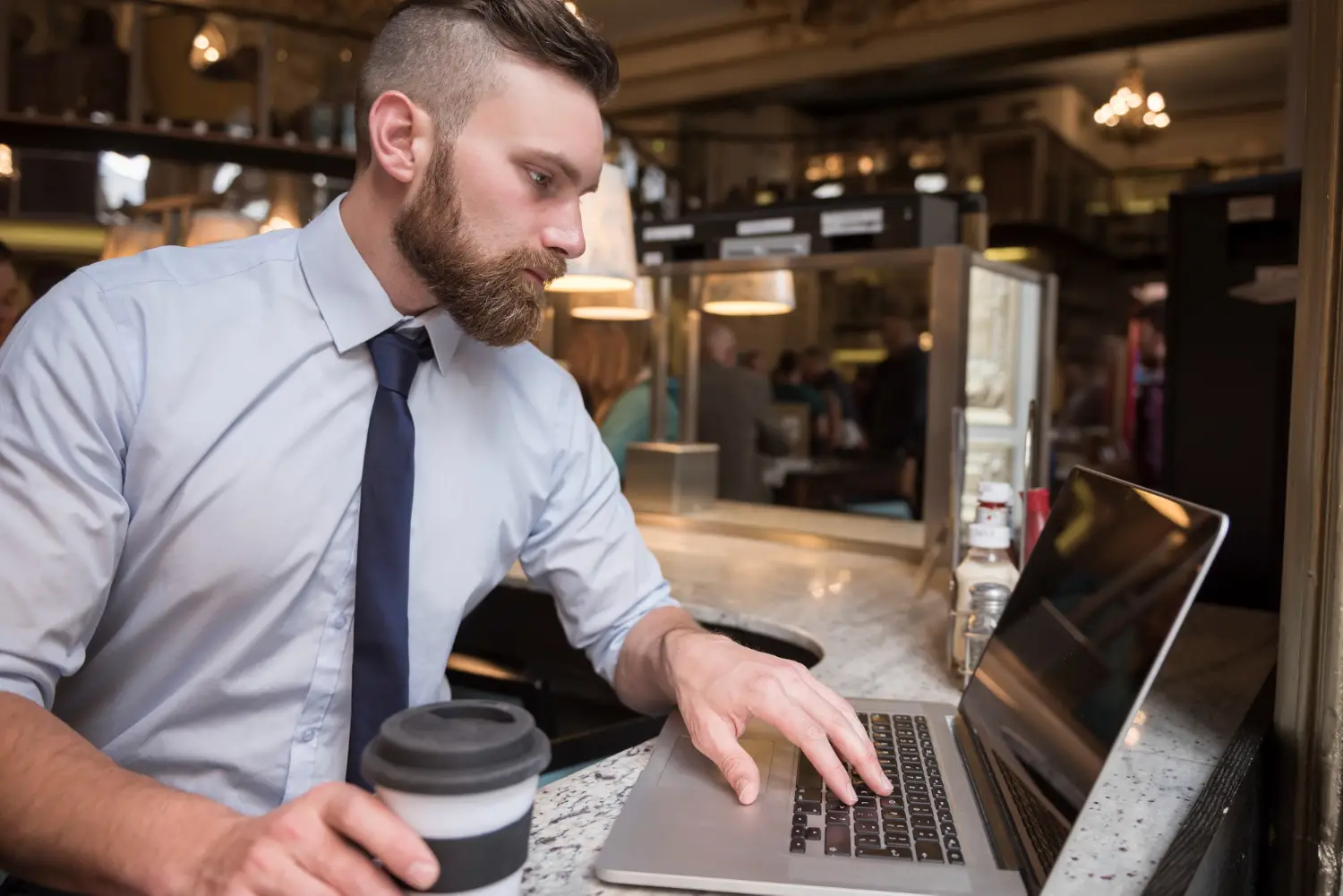 Manager using EPOS back office to review menu performance and pricing